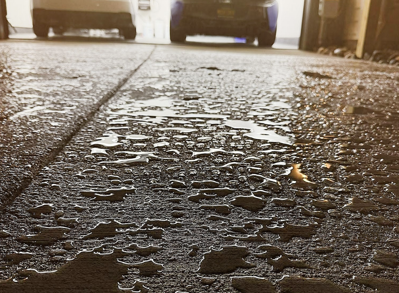 Beads of water on sealed concrete surface